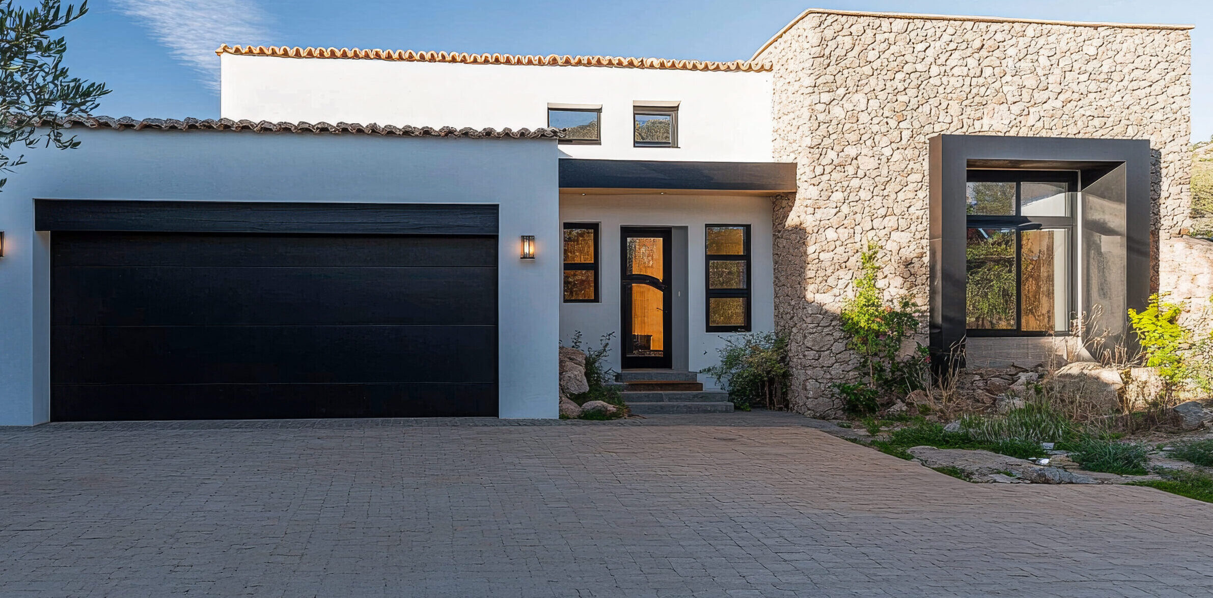 Modern stone house with elegant design and serene landscape in bright daylight